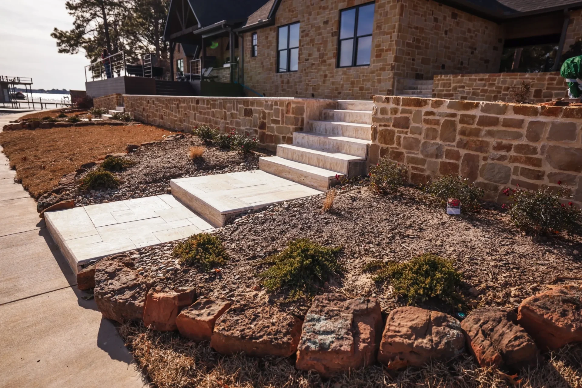 A house with steps and plants in the yard.