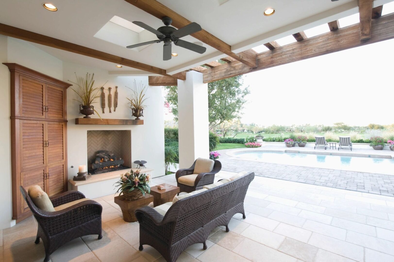 A patio with furniture and a fireplace in it